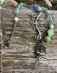 Nature themed beaded necklace with charms and leaf accents