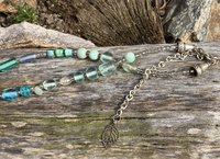 Nature themed beaded necklace with charms and leaf accents