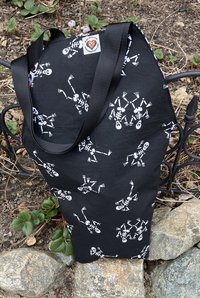 Handmade coffin bag by Lucky Burrito with dancing skeletons on black fabric with coordinating black, white and red graffiti fabric