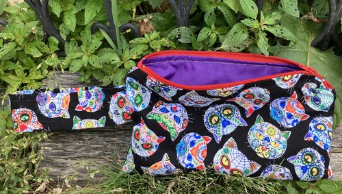 Handmade zippered wristlet bag (Clutch) Large by Lucky Burrito featuring cat skeletons on black fabric