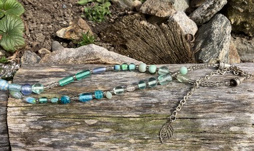 Nature themed beaded necklace with charms and leaf accents