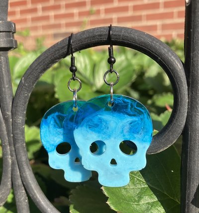 Resin blue toned skull earrings